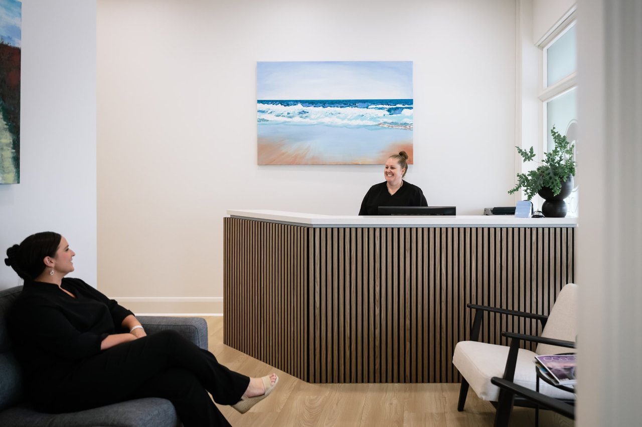 The waiting room and front desk at Flinders Dental Practice, with two of our team